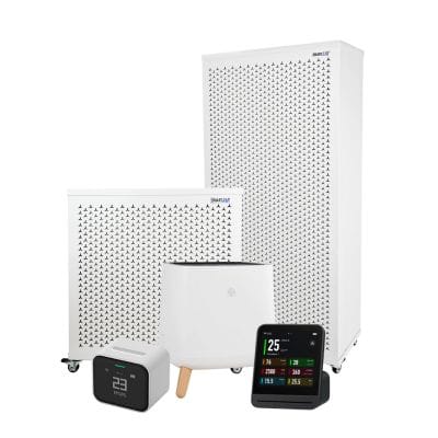 air purifier and air quality monitors on white background