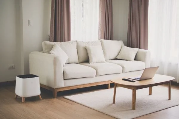 The Sqair with beautiful design next to a couch in a living room