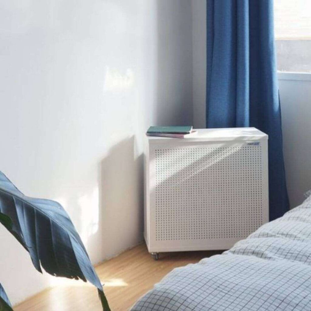 Blast air purifier in a living room blast mini air purifier in the corner of a bedroom