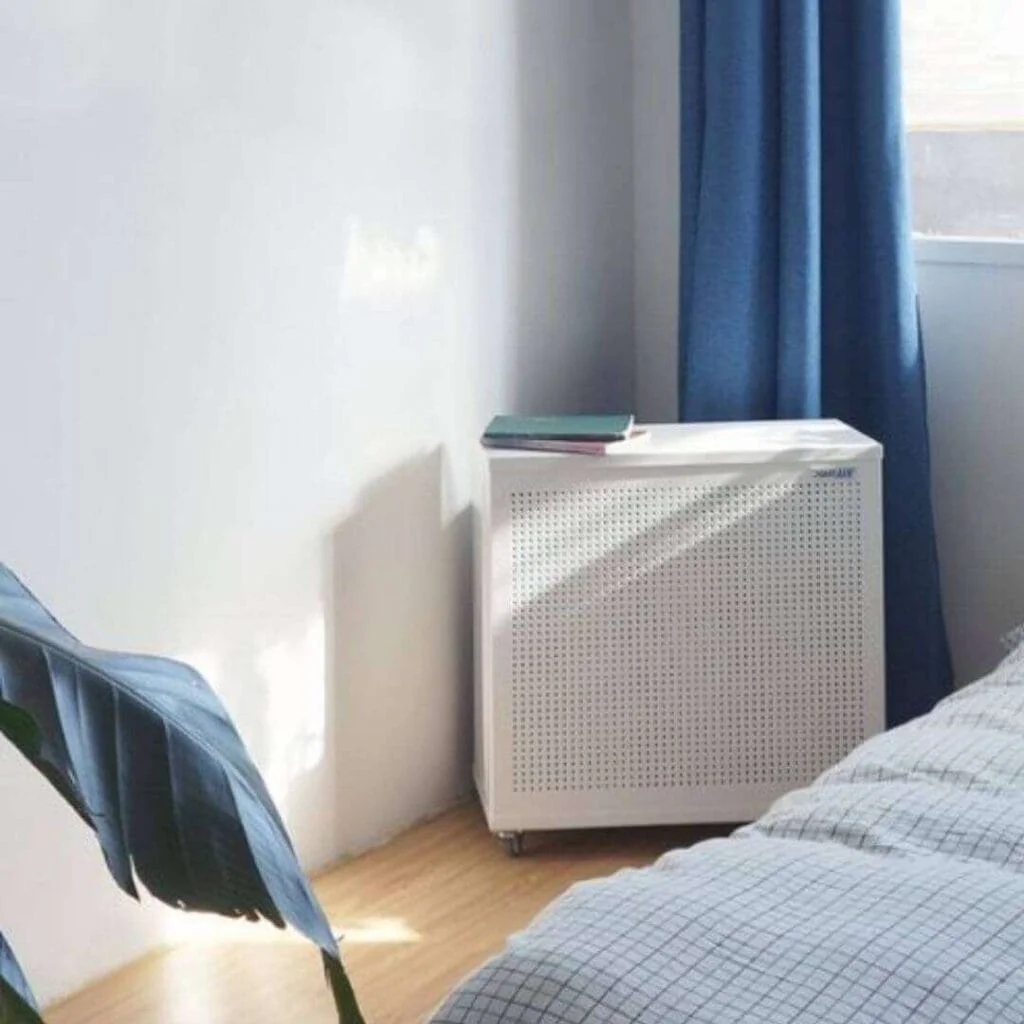 blast mini air purifier in the corner of a bedroom