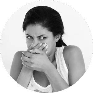 a woman covering her nose from smells