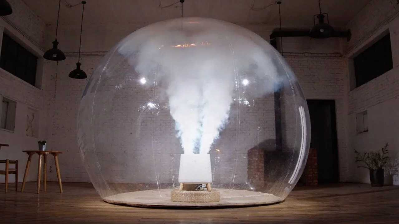 the sqair air purifier in a plastic bubble with smoke