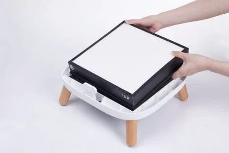a person inserting a hepa filter into an air purifier