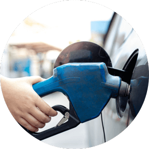 a hand filling benzene into a car