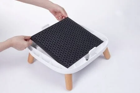 a person inserting a carbon filter into an air purifier