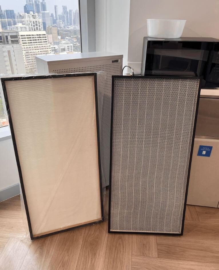 two hepa filters next to each other. one is used and black, the other one is white and new