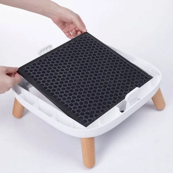 a person inserting a carbon filter into an air purifier