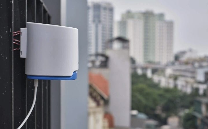outdoor air pollution monitor fixed on a railing